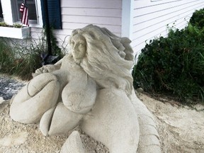 This July 7, 2016 photo shows the mermaid sand sculpture in front of Salty's Seafood Restaurant in West Yarmouth, Mass. Here, the sand sculpture is under a small tent enclosure outside the restaurant and is part of a larger collection of sculptures throughout Yarmouth. (Steve Haines/Cape Cod Times via AP)