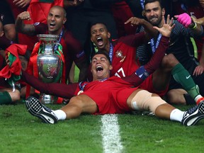 Cristiano Ronaldo and Portugal players celebrate after their 1-0 win against France in the UEFA EURO 2016 Final match between Portugal and France at Stade de France on July 10, 2016 in Paris, France.  (Photo by Lars Baron/Getty Images)