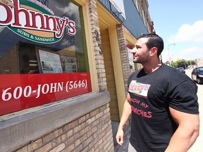 A.J. (Ege) Zorlu stares off at the Johnny's Sub & Sandwich sign. He recently purchased the business from John Hunt who died on June 28. The young entrepreneur wants the community to know the restaurant will always be Johnny’s.  (Shaun Gregory/Huron Expositor)
