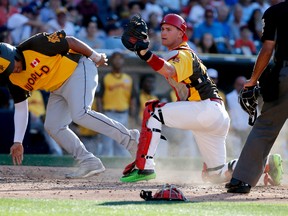 World Team's Josh Naylor, of the Miami Marlins, is out at the plate as U.S. Team' Kelly Carson, of the St. Louis Cardinals, holds on to the ball after the tag during the sixth inning of the All-Star Futures baseball game, July 10, 2016, in San Diego. (LENNY IGNELZI/AP)
