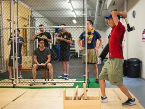 Richard Wu, a friend of Howard An, who is getting married in October, has fun at an Axe Throwing Club as part of An's bachelor party, in Toronto on Saturday July 9 , 2016. THE CANADIAN PRESS/Eduardo Lima