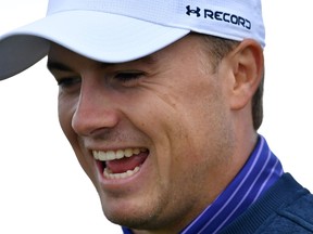 U.S. golfer Jordan Spieth smiles as he leaves the 4th tee during practice on July 11, 2016, ahead of the 2016 British Open Golf Championship at Royal Troon in Scotland. (USEBEN STANSALL/AFP/Getty Images)