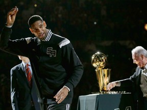 In this Oct. 28, 2014, file photo, San Antonio Spurs' Tim Duncan, left, holds up his 2014 NBA championship ring during a ceremony prior to an NBA basketball game between the Spurs and the Dallas Mavericks, in San Antonio. Duncan announced his retirement on Monday, July 11, 2016, after 19 seasons, five championships, two MVP awards and 15 All-Star appearances. It marks the end of an era for the Spurs and the NBA. (AP Photo/Eric Gay, File)