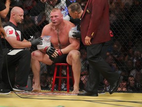 Brock Lesnar in between rounds gets instructions from his coach against  Mark Hunt (R) during the UFC 200 event at T-Mobile Arena on July 9, 2016 in Las Vegas, Nevada. (Photo by Rey Del Rio/Getty Images)