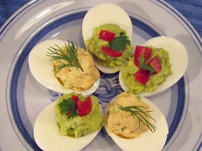 This Tuesday, July 5, 2016 photo shows stuffed eggs with tuna, topped with dill, and guacamole, topped with tomatoes, in New York. This dish is from a recipe by Sara Moulton. (Sara Moulton via AP)