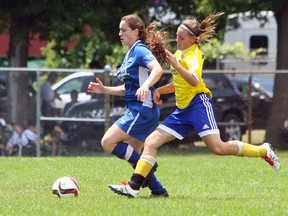 Cambridge United's Logann Pereira, left, battles Kingston Clippers' Carsyn Newton during under-18 division action at the Ambassador Cup girls soccer tournament at Caton's Field on Saturday. The Clippers advanced to the division final. (Steph Crosier/The Whig-Standard)