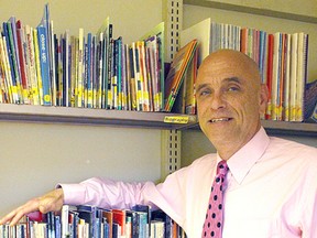 Chuck Dowdall, the new executive director of Kingston Literacy & Skills, stands with shelves of English learning books at his office on Bath Road in Kingston, Ont. on Tuesday July 5, 2016. Julia Balakrishnan for the Whig-Standard/Postmedia Network
