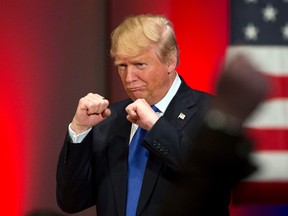 Republican presidential candidate Donald Trump poses with a ring given to him by a group of veterans during a campaign event on the campus of Drake University in Des Moines, Iowa. (AP Photo/Jae C. Hong)