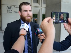 Buffalo Sabre Ryan O'Reilly, centre, talks to the press outside the courthouse in London, Ontario on Monday July 11, 2016 after being found not guilty of impaired driving after a crash into a Tim Horton's coffee shop north of London last summer
(MORRIS LAMONT/THE LONDON FREE PRESS / POSTMEDIA NETWORK)
