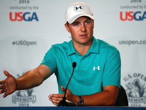 In this June 13, 2016, file photo, defending U.S. Open champion Jordan Spieth talks with reporters after a practice round for the 2016 U.S. Open golf championship at Oakmont Country Club in Oakmont, Pa. Spieth is out of the Olympics. International Golf Federation president Peter Dawson announced the decision at the British Open. Spieth had been strongly debating whether to go over the last three days before reaching his decision on Monday, July 11, 2016. He will be replaced by Matt Kuchar. (AP Photo/Gene J. Puskar)