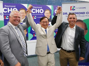 Campaign boss Doug Ford, left, and PC Leader Patrick Brown, right, flank Raymond Cho at the opening of his byelection campaign office Monday July 11, 2016. (Michael Peake/Toronto Sun)