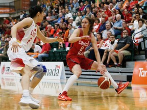 Canada's Kim Gaucher is hassled by China's Lu Wen during the Edmonton Grads International Classic basketball game between Canada and China at the Saville Community Sports Centre on Monday. (Codie McLachlan)