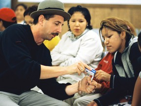 Sarnia's Mike Stevens works with young people during a visit to First Nations community. The Canadian Country Music Association announcement Monday Stevens, founder of the charity ArtsCan Circle, will receive a humanitarian award during Country Music. (Handout)