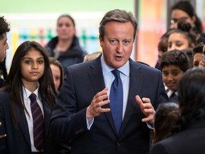 Britain's Prime Minister David Cameron talks to pupils during a visit to Reach Academy Feltham in south west London, Tuesday July 12, 2016. British Prime Minister David Cameron chaired a farewell Cabinet meeting Tuesday before handing over power to his successor following the historic vote to leave the European Union. Ministers gathered for the final session a day after Home Secretary Theresa May was confirmed as the new Conservative leader and prime minister-in-waiting. (Chris J. Ratcliffe/Pool via AP)
