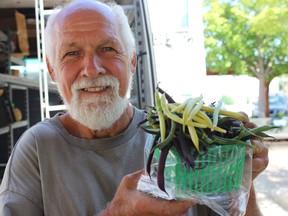 Samantha Reed/The Intelligencer
Harry McMurter of Charlen Organic Farm holds a basket full of beans Tuesday morning at the Belleville farmers' market. McMurter is one of the many farmers in the area who are growing concerned with the constant heat and lack of rain.