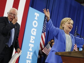 Democratic presidential candidate Hillary Clinton, accompanied by Sen. Bernie Sanders, I-Vt., speaks at a rally in Portsmouth, N.H., Tuesday, July 12, 2016, after Sanders introduced her and endorsed her for president. (AP Photo/Andrew Harnik)