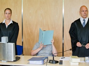 Defendant Andrea G (C) sits between her lawyers Julia Gremmelmaier (L) and Till Wagler (R) as she waits for the opening of her trial at the district court of Coburg, central Germany, on July 12, 2016. Andrea G and her husband Johann G are accused of murder and attempted murder of their children. In November 2015, police have discovered the bodies of eight dead babies in apartment that was inhabited by Andrea and Johann G. (DANIEL KARMANN/AFP/Getty Images)
