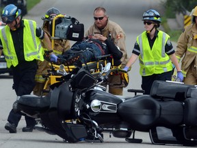 One of two men injured in a collision between a motorcycle and a bicycle is taken from the scene, just east of Stratford, Ont. (File photo)