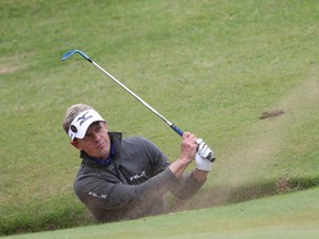 Luke Donald plays out of a sand trap on the 8th hole during a practice round for the British Open at the Royal Troon Golf Club in Troon, Scotland, Tuesday, July 12, 2016. (AP Photo/Peter Morrison)