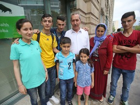 Khuder Nasa, Munifa Hussein, and their six children have arrived, safely, in Winnipeg. Then family are Yazidis, from Northern Iraq, and were displaced by fighting. They spent two years in a refugee camp, before arriving in Canada. (Chris Procaylo/Winnipeg Sun)