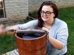 Danielle McMahon-Jones of Glanmore National Historic Site demonstrates the ice cream churn at the museum in Belleville Tuesday. Staff are offering chances to try Victorian-era games and ice cream making this summer.