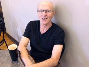 Queen's University professor John McGarry, who received the Molson Prize from the Canada Council for the Arts and Social Sciences and Humanities Research Council on Monday, sits at Coffe & Company on Tuesday. (Julia Balakrishnan/For The Whig-Standard)
