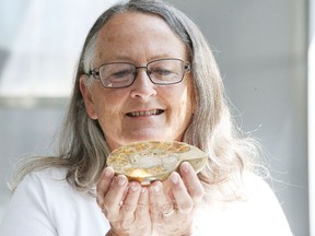 Gino Donato/Sudbury Star
Ruth Debicki, vice president of the Sudbury Rock and Lapidary Society, shows off a nautiloid shell on Tuesday. The 34th annual Sudbury Gem and Mineral Show goes this weekend at the Carmichael Arena.