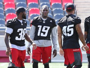 #19 Imoan Claiborne talks to #38 Tristan Jackson and #45 Damaso Munoz of the Ottawa Redblacks. (Jean Levac, Postmedia Network)