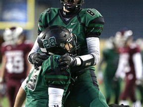 Vincent Massey Trojans receiver Brayden Saville (top) congratulated SB Jeremy Gillis on his touchdown reception against the St. Paul's Crusaders during the WHSFL AAA championship game in Winnipeg on Fri., Nov. 13, 2015. Kevin King/Winnipeg Sun/Postmedia Network