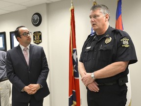 Josh Devine with the Tennessee Bureau of Investigation, left, looks on as Bristol Tennessee Chief of Police Blaine Wade gives an update of an early morning shooting in Bristol, Tenn., on Thursday, July 7, 2016.  Police say multiple people have been injured and one person was taken into custody after a man opened fire on motorists traveling along a parkway in East Tennessee. Bristol police say the incident happend early Thursday in the city along the Virginia border. (David Crigger/The Bristol Herald-Courier via AP)