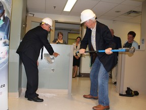 Roger Deeley, left, helps David Pattendon pick the right spot as they mark the beginning of construction on the W. J. Henderson Centre for Patient-Oriented Research at Kingston General Hospital on Tuesday July 12, 2016. Jane Willsie for The Kingston Whig Standard/Postmedia Network