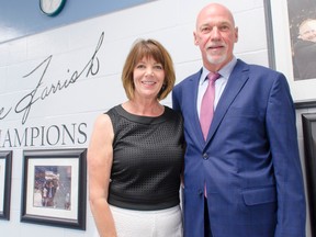 Retired NHL defenseman, current Colorado Avalanche assistant coach and Lucknow native Dave Farrish, right, poses with his wife Roxanne Farrish before a wall of photographs in the Lucknow arena commemorating his 2007 Stanley Cup championship with the Anaheim Ducks. The wall was unveiled during the Dave Farrish Champions Chamber room dedication Saturday, July 9, 2016, in front of almost 100 of his friends and family. The event was part of an entire Day Farrish Day that was planned by the community to celebrate Farrish's hockey accomplishments and commitment to his home community. (Darryl Coote/Reporter)