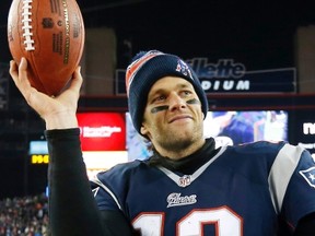 In this Jan. 10, 2015, file photo, New England Patriots quarterback Tom Brady holds up the game ball after an NFL divisional playoff football game against the Baltimore Ravens in Foxborough, Mass. On Wednesday, July 13, 2016, a federal appeals court has rejected Tom Brady's attempt to get a new hearing on his suspension. (AP Photo/Elise Amendola, File)