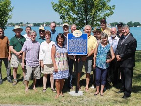 Members of the St. Clair Township Heritage Committee pose with members of St. Clair Township council, Lambton County Warden Bev MacDougall and historian John Carter at the newly unveiled plaque at Sombra's Riverside Park, which commemorates the events of June 28, 1838, when a group of insurgents raided Sombra. 
CARL HNATYSHYN/SARNIA THIS WEEK