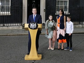 Britain's Prime Minister David Cameron speaks to the press outside 10 Downing St. in London, Wednesday July 13, 2016, as his wife Samantha and their children Nancy, Elwen, right, and Florence, third right, look on.  (AP Photo/Kirsty Wigglesworth)