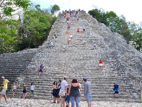 Climbing Cobá's Nohoch Mol pyramid is made somewhat easier by grabbing on to the safety rope, but it is still is a challenge going both up and down. (Martha Lowrie/Special to Postmedia Network)