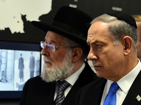Israeli Prime Minister Benjamin Netanyahu (R) and Rabbi Yisrael Meir Lau look at the displays at the opening of the Permanent Exhibition SHOAH at former Nazi death camp in the Auschwitz-Birkenau State Museum, Block 27 in Oswiecim on June 13, 2013.  (JANEK SKARZYNSKI/AFP/Getty Images)