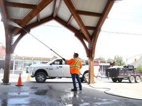 Jason Miller/The Intelligencer
Joe Morton, of the city parks department, washes away some dirt from the underside of the roof at Belleville's Market Square. While the city’s parks department is making efforts to conserve water the city’s manager of environment services said the city isn’t seeing any capacity issues when it comes to water.