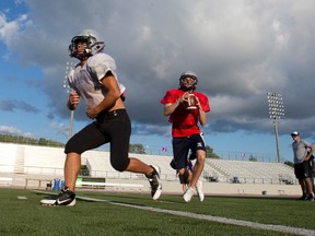 Jr. Mustangs quarterback Tristan Arndt looks down the field after faking a handoff to running back Brentyne AndersonBrown (cct) during practice at TD Stadium in London, Ont. on Sunday August 18, 2013. Craig Glover/The London Free Press/Postmedia Network