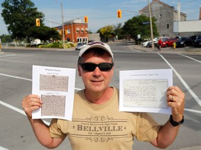 Filmmaker Doug Knutson holds copies of 1816 documents showing the naming of Belleville Wednesday. He stands near where residents first proposed the name: in a now-destroyed tavern at Dundas and Front Streets.