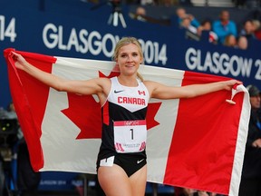 Canada’s Brianne Theisen-Eaton celebrates after winning the heptathlon at Hampden Park Stadium during the 2014 Commonwealth Games in Glasgow, Scotland on July 30, 2014. (THE CANADIAN PRESS/AP, Frank Augstein)