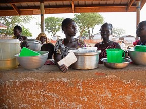 Newly arrived refugees from South Sudan queue to receive food at the Nyumanzi transit centre in Adjumani on July 13, 2016. (AFP PHOTO / Isaac KasamaniISAAC KASAMANI/AFP/Getty Images)