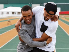 Andre DeGrasse, left, and Wallace Spearmon horse around on the Foote Field track Wednesday. (Ian Kucerak)
