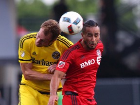 Toronto FC forward Mo Babouli goes up for a header against Columbus Crew defender Tyson Wahl during last night’s game. (AP)