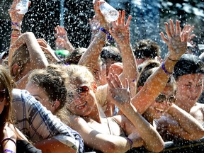 Fans coping with the extreme hot temperatures are hosed down by security as the country band Old Dominion opens the Rock the Park Country concert in Harris Park on Wednesday July 13, 2016. 
MORRIS LAMONT  / THE LONDON FREE PRESS / POSTMEDIA NETWORK