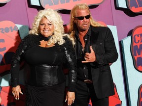 In this June 4, 2014 file photo, Beth Chapman, left, and Duane Chapman arrive at the CMT Music Awards at Bridgestone Arena, in Nashville, Tenn. Hawaii's attorney general says "Dog the Bounty Hunter" reality TV star Duane "Dog" Chapman's bail bonds business owes the state $35,000. Attorney General Doug Chin says Wednesday, July 13, 2016, his office is suing Da Kine Bail Bonds for money it promised to pay when the company's clients skipped court. (Photo by Wade Payne/Invision/AP, File)