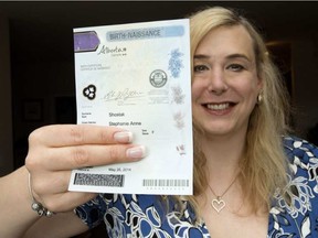 Stephanie Shostak holds her birth certificate Wednesday in her Edmonton home. Shostak is one of nearly 300 Albertans that have changed the gender marker on their birth certificate since a court decision forced Alberta to change the rules two years ago. DAVID BLOOM / POSTMEDIA