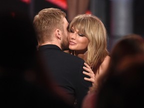 In this May 17, 2015 file photo, Taylor Swift, right, hugs Calvin Harris after winning the award for top billboard 200 album for "1989" at the Billboard Music Awards at the MGM Grand Garden Arena  in Las Vegas. Swift has confirmed that she co-wrote ex-boyfriend’s Calvin Harris’ latest hit song under an alias, which prompted the DJ-producer to send a series of angry tweets Wednesday, July 13, 2016. (Photo by Chris Pizzello/Invision/AP)