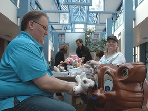 Peter, left, and Stephanie McDermid of Bear Friend Factory stuff 100 ER buddies -- stuffed teddy bears of various descriptions -- for love and attention from young children being attended to in the emergency department at St. Thomas Elgin General Hospital.