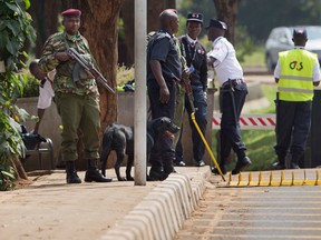 FILE PHOTOS Armed Kenyan police and private security guard the entrance to the Canadian High Commission after a bomb scare in Nairobi, Kenya Thursday, June 16, 2016. (AP Photo/Ben Curtis)
